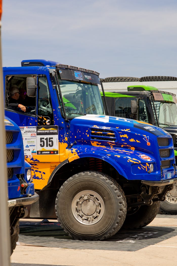 Dynamic view of a vibrant racing truck at motorsport event, ready for competition.